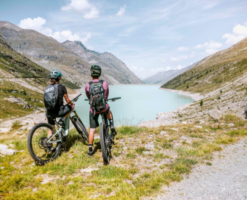 Two cyclists overlooking a serene lake