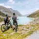 Two cyclists overlooking a serene lake